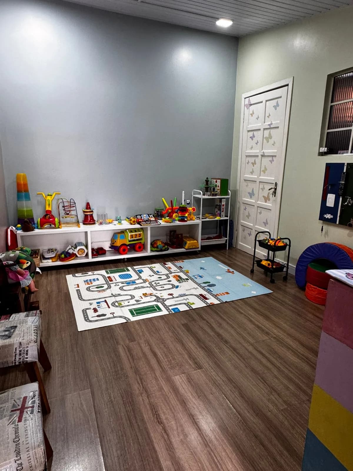 Sala de atendimento infantil da SF Centro Terapêutico, com brinquedos e tapete de atividades.